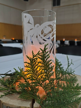 Illuminated glass vase centrepiece with cedar greenery