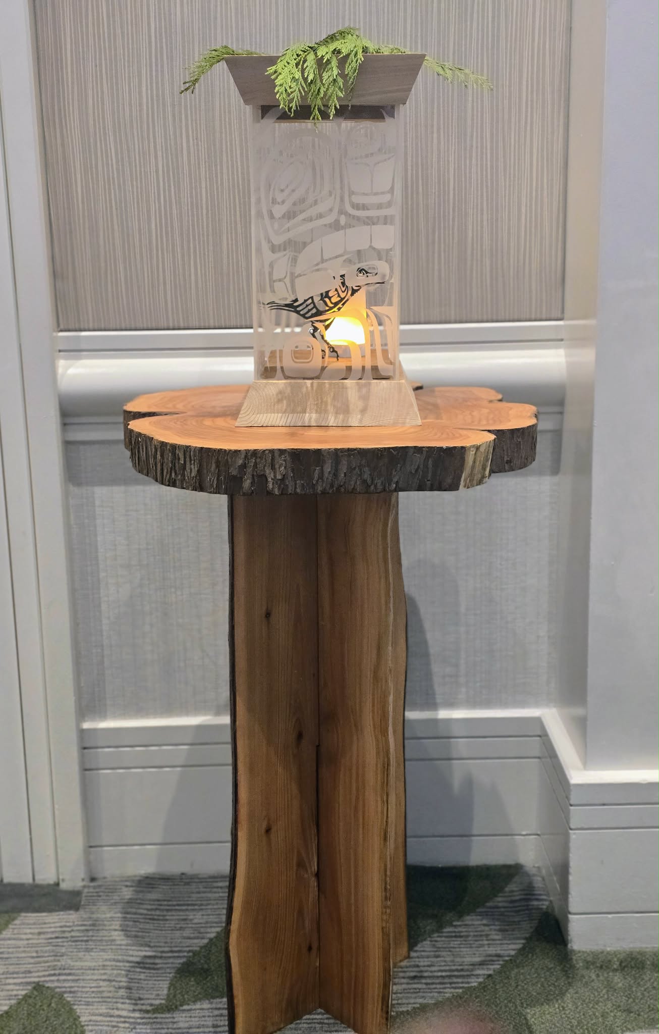 Live-edge display table with illuminated Raven and Sun piece